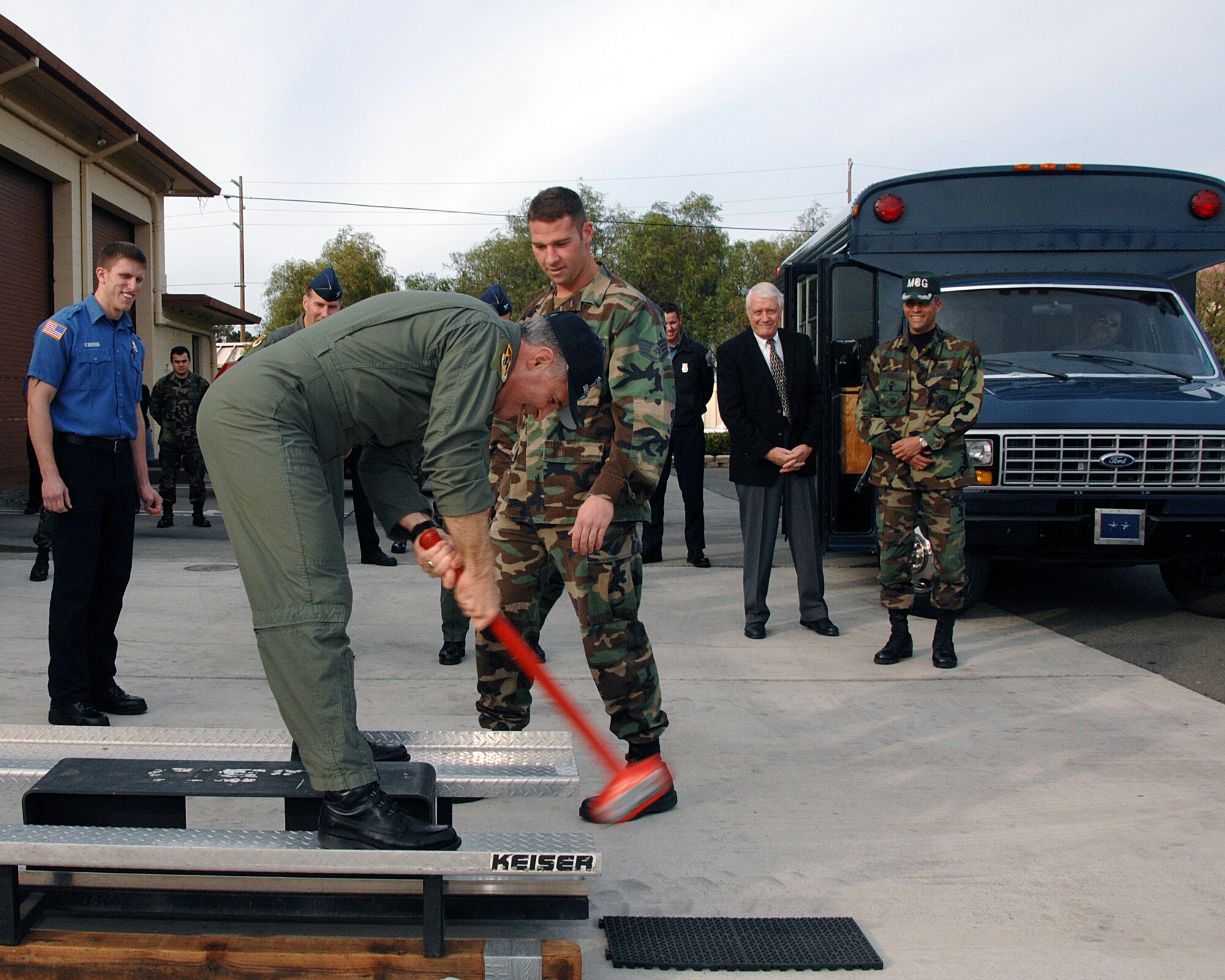 Maj. Gen. James Hawkins, 18th Air Force commander, tries his hand at the Keiser Sled while visiting at Travis’ main fire station Feb. 15. The general was there to meet the Team Travis’ World Firefighter Combat Challenge Team, who recently won their third consecutive World Firefighter Combat Challenge title. The Keiser Sled is one of the events the firefighters competed in during the World Firefighter Combat Challenge. (U.S. Air Force photo by David Cushman)