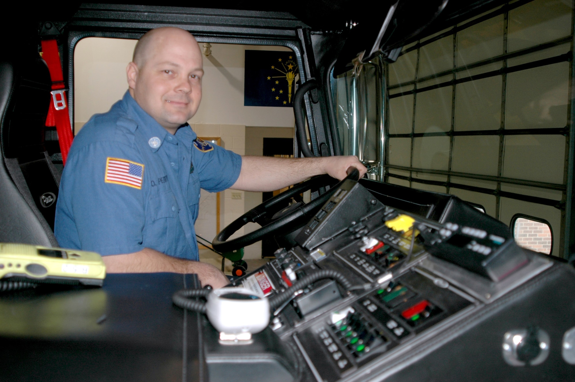 GRISSOM AIR RESERVE BASE, Ind., -- David Perryman of Greentown, Ind., the driver of Rescue 5, sits behind the wheel of Grissom's latest fire truck. Rescue 5 provides first responders a valuable tool when responding to accidents and incidents both on and off base. The heavy duty rescue vehicle was put into service recently and is proving to be a valuable asset to both the base and the community. (U.S. Air Force photo/Tech. Sgt. Doug Hays)