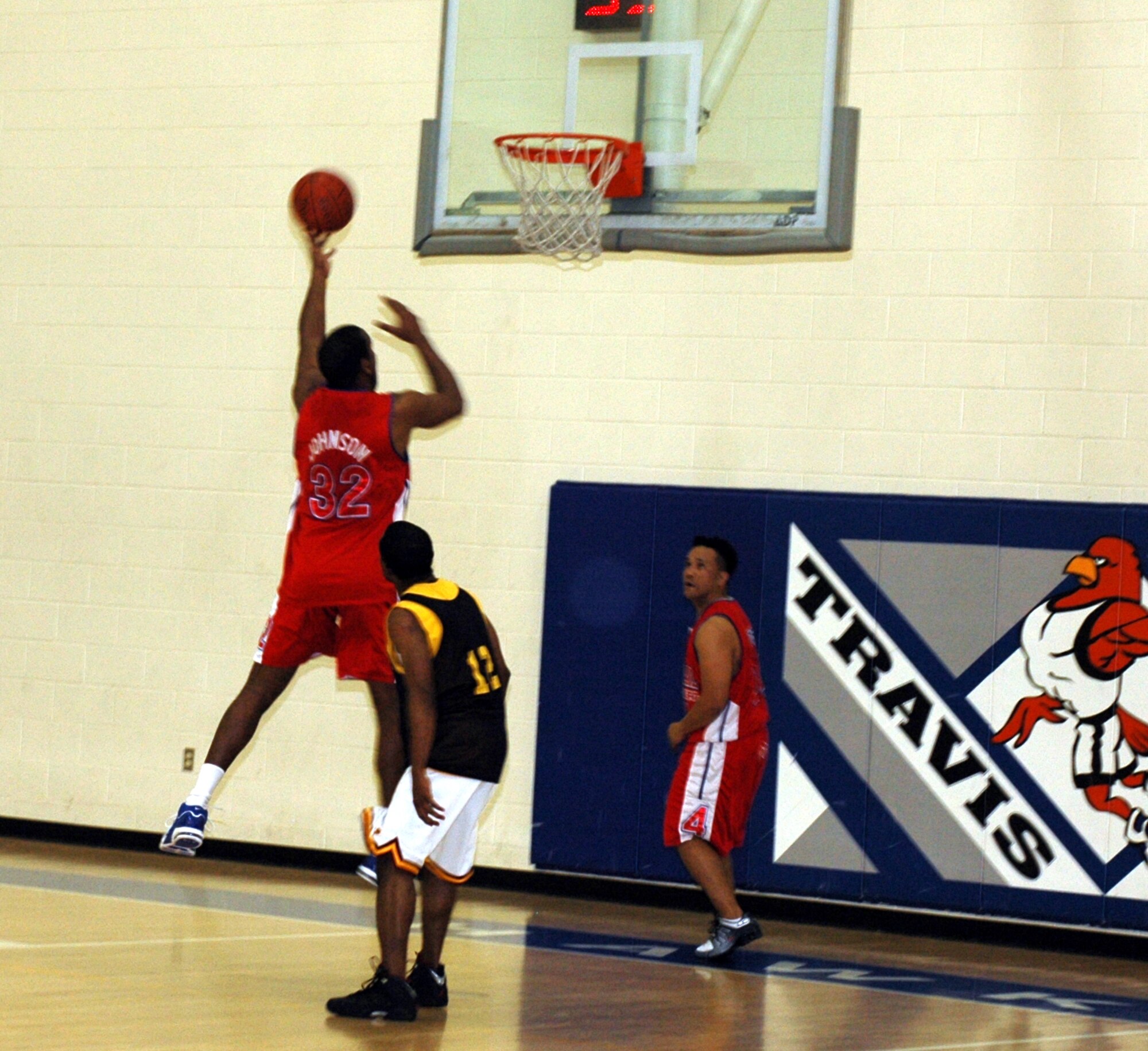 Fred Johnson, (#32), 60th Aerial Port Squadron’s center, hits a layup during his team’s 49-44 victory over the 60th Medical Operations Squadron Feb. 20. Johnson was his team’s leading scorer with 15 points. (U.S. Air Force photo by Staff Sgt. Candy Knight)