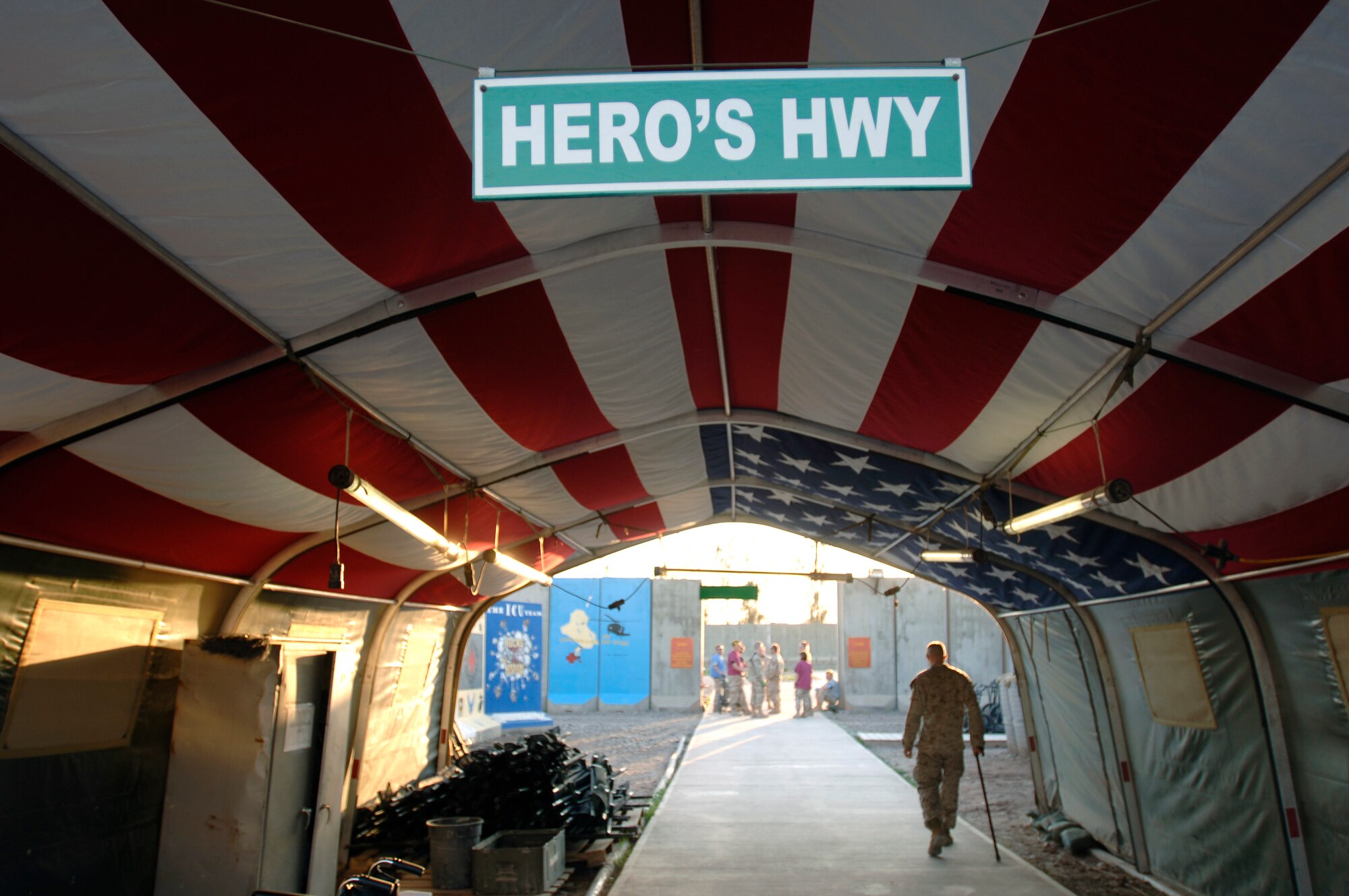 Each month, hundreds of wounded Soldiers, Airmen, Marines, Sailors and Iraqi personnel pass underneath the American flag canopy through Heroes' Highway at Balad Air Base, Iraq. Ninety eight percent of the patients treated at Balad's Air Force Theater Hospital survive. (U.S. Air Force photo/Tech. Sgt. Cecilio M. Ricardo Jr.) 