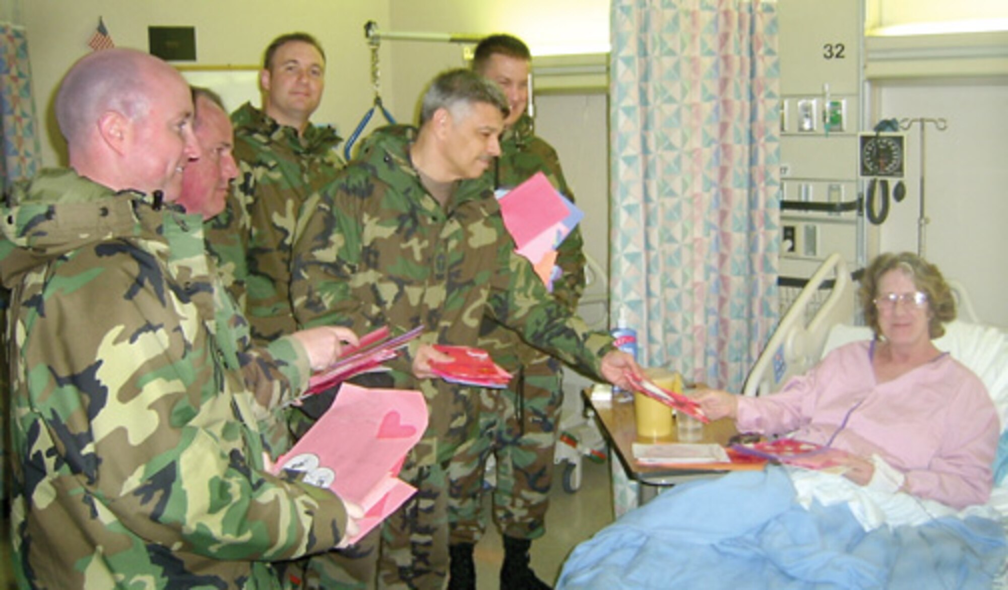 From left Tech. Sgt. Jeffrey Coleman, Master Sgt. Steven Ford, Tech. Sgt. Michael Dambrino, Chief Master Sgt. Everett Smith and Master Sgt. Keith Nestinger bring valentines to a hospitalized former Soldier Feb. 14.