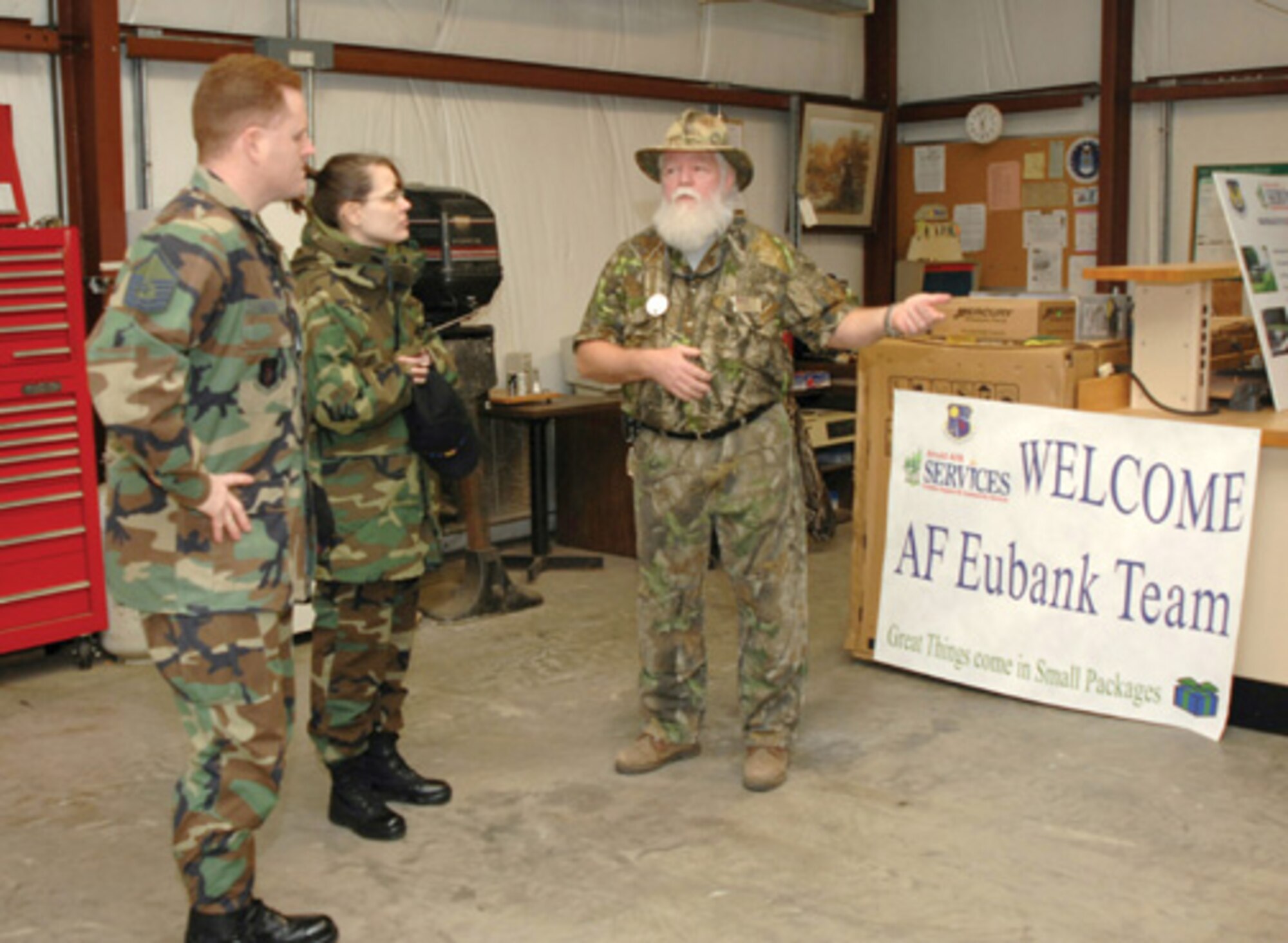 Recreation specialist Charles Evans explains the functions of the Marina Maintenance Building to Maj. Danielle Taylor and Master Sgt. Jeffrey Gideon, two team leaders of the Maj. Gen. Eugene L. Eubank Evaluation Team.