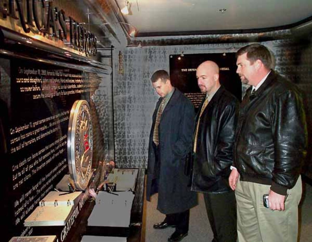 FBI Special Agents Garrett McKenzie, Thomas O'Connor and  Chris Mayfield visit the Pentagon Memorial for the first time, Feb. 3,  2003. They hadn't been to the Pentagon since spending three weeks on  the FBI evidence team after Sept. 11, 2001, terrorist attack on the  building. Photo by Rudi Williams.