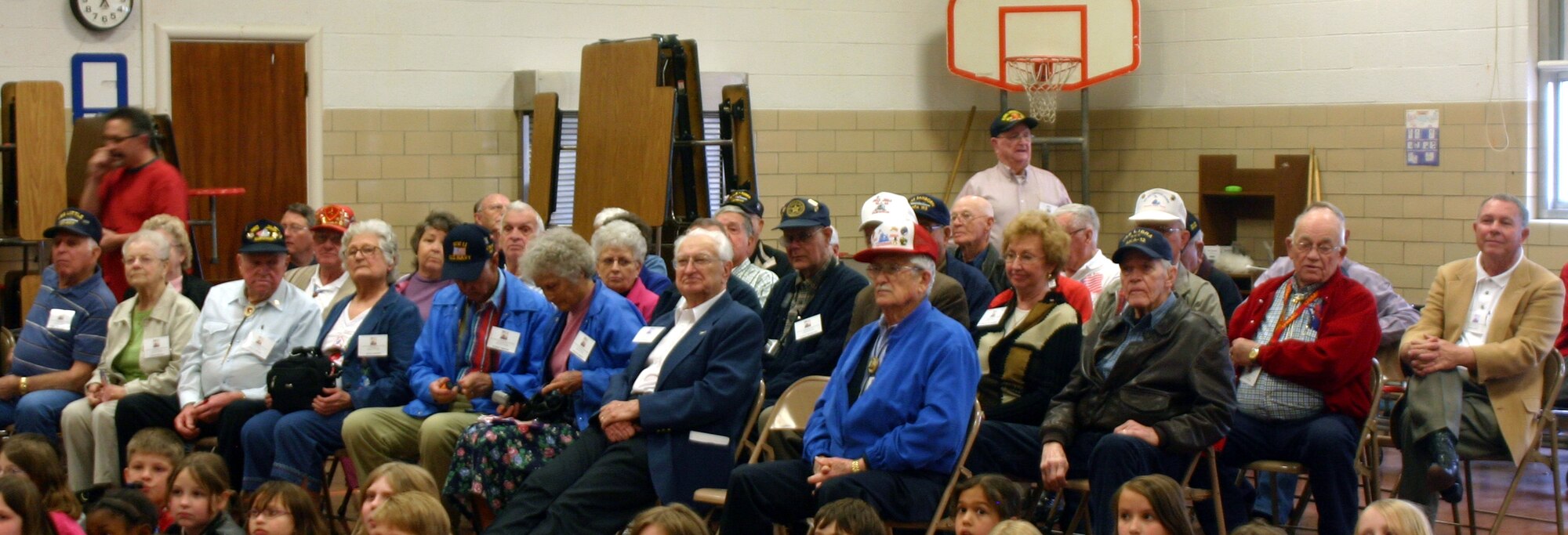 Members of the Iwo Jima Survivors Reunion end their yearly tour of Sheppard AFB with a visit to Sheppard Elementary School.  Iwo Jima veterans, their wives and widows enjoy the school's choir singing "What Do You Say to a Hero?" (U.S. Air Force Photo/Staff Sgt. Tonnette Thompson)