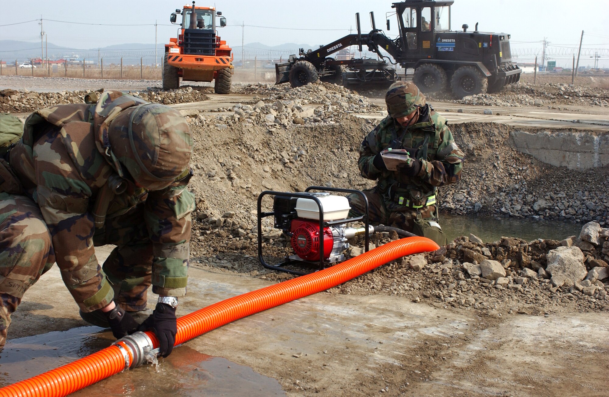 Airmen from the 8th Civil Engineer Squadron airfield damage repair team prepare a crater for repair Feb. 21. during an operational readiness exercise at Kunsan Air Base, Korea.  ADR teams do everything from crater repair to airfield lighting making it possible to get aircraft back in the air quickly. (U.S. Air Force Photo/Master Sgt. Jack Braden)