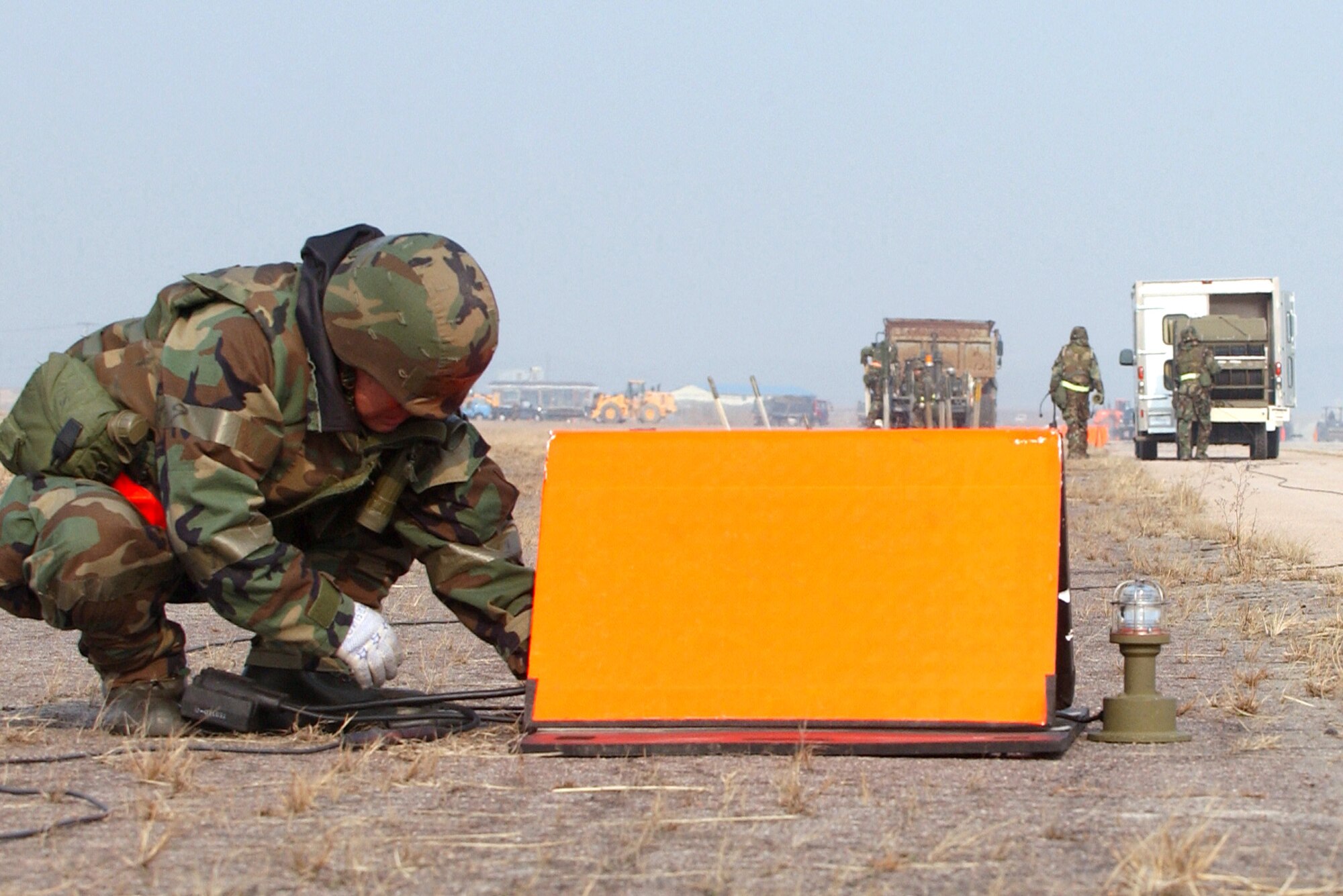 Airmen from the 8th Civil Engineer Squadron airfield damage repair team install temporary runway lighting Feb. 21 during an operational readiness exercise at Kunsan Air Base, Korea.  ADR teams do everything from crater repair to airfield lighting making it possible to get aircraft back in the air quickly. (U.S. Air Force Photo/Master Sgt. Jack Braden)