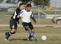 John Cardenas, right, from the Lackland Varsity Soccer Team, works to keep possession against a defender from Schriever Air Force Base, Colo., Feb. 16 during the early rounds of the fifth Alamo City Military Open Soccer Tournament for the Defender's Cup on Lackland Air Force Base, Texas. (USAF photo by Robbin Cresswell)
