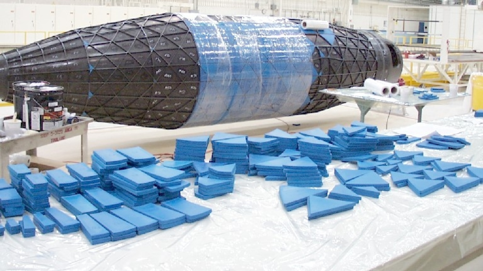 The application of rubber tooling to the composite payload fairing supports the finished ribs at Boeing Phantom Works in Seattle. (Air Force photo)