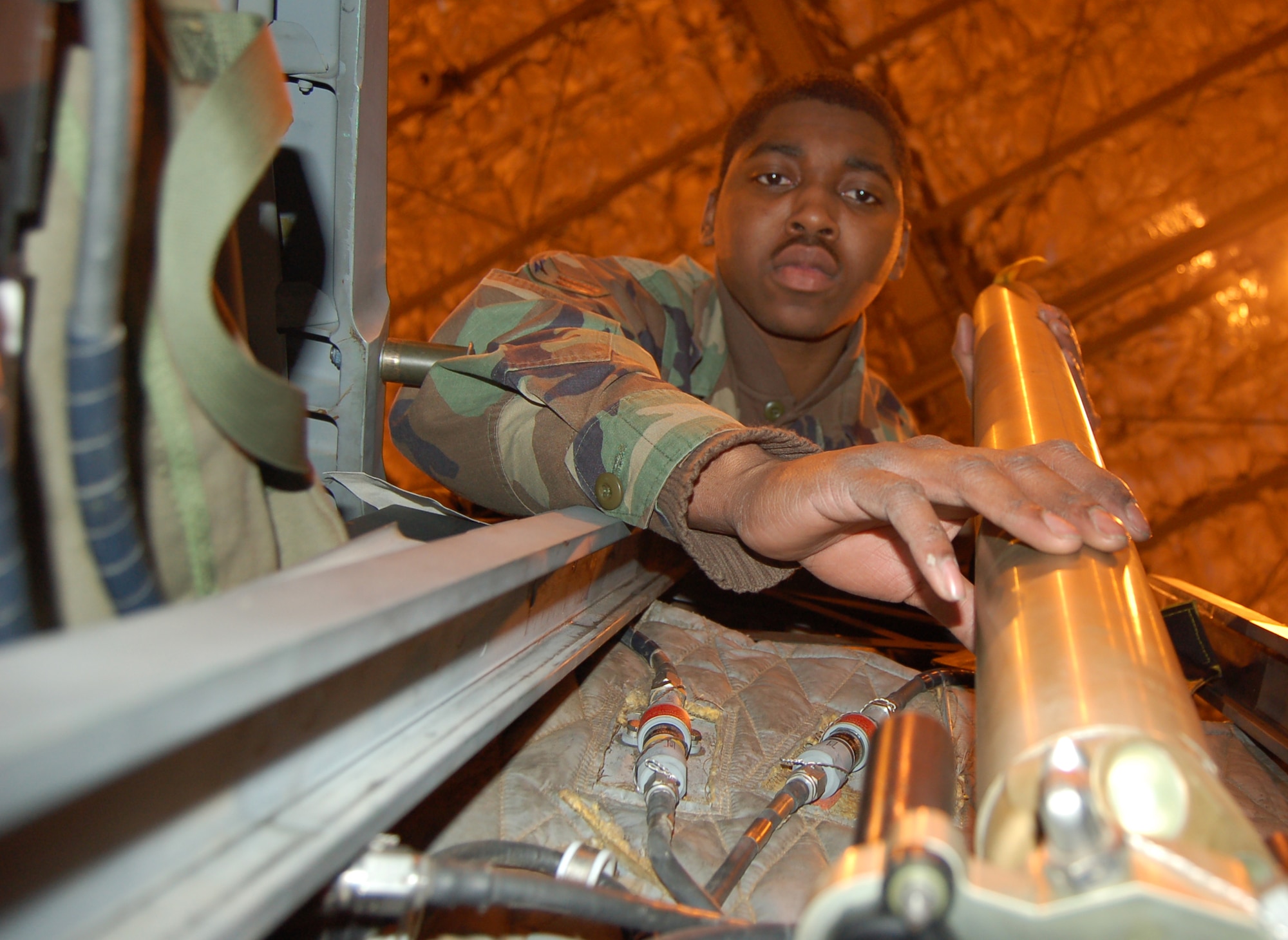 Airman 1st Class Keith Billings verifies the ballistic fitting elbows on a CKU-5B/A rocket catapult are in their proper place during the egress portion of an aircraft transfer inspection Feb. 22 at Elmendorf Air Force Base, Alaska. The rocket catapult ejects the seat in the F-15E Strike Eagle at 43 feet per second. This is part of the aircraft transfer inspection is one of the steps changed under Elmendorf AFB's Air Force Smart Operations for the 21st century aircraft transfer program. Instead of taking 10 days, the inspection is now complete in three. Airman Billings is an aircrew egress journeyman with the 3rd Component Maintenance Squadron. (U.S. Air Force photo/Staff Sgt. Matthew Rosine) 
