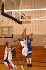 Fort Sill, Okla., Cannoneer Michael Smith attempt to block Warhawks' Paul Parkers shot during the final championship game of the Southwest Military Basketball League championship Feb. 18 at Brooks City-Base, Texas. The men's varsity basketball team from Lackland Air Force Base, Texas, won against the Cannoneers, 87-69. (USAF photo by April Blumer)                                