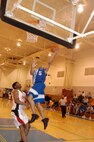 Warhawks' Lorenzo Smith puts air under his feet as he sends the ball up for two during the final championship game of the Southwest Military Basketball League championship Feb. 18 at Brooks City-Base, Texas. The men's varsity basketball team from Lackland Air Force Base, Texas, won against the Fort Sill, Okla., Cannoneers, 87-69. (USAF photo by April Blumer)                                