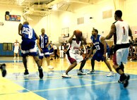 Warhawks' Patrick Stewart guards Cannoneer's Michael Smith after a rebound during the final championship game of the Southwest Military Basketball League championship Feb. 18 at Brooks City-Base, Texas. The men's varsity basketball team from Lackland Air Force Base, Texas, won against the Fort Sill, Okla., Cannoneers, 87-69. (USAF photo by April Blumer)                                