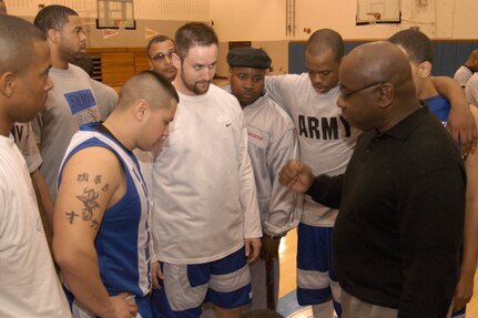 Warhawks' head coach, Jerome Riley, talks to his team about how to defend the championship title prior to the start of the final championship game of the Southwest Military Basketball League championship Feb. 18 at Brooks City-Base, Texas. The men's varsity basketball team from Lackland Air Force Base, Texas, won against the Cannoneers, 87-69. (USAF photo by April Blumer)                                