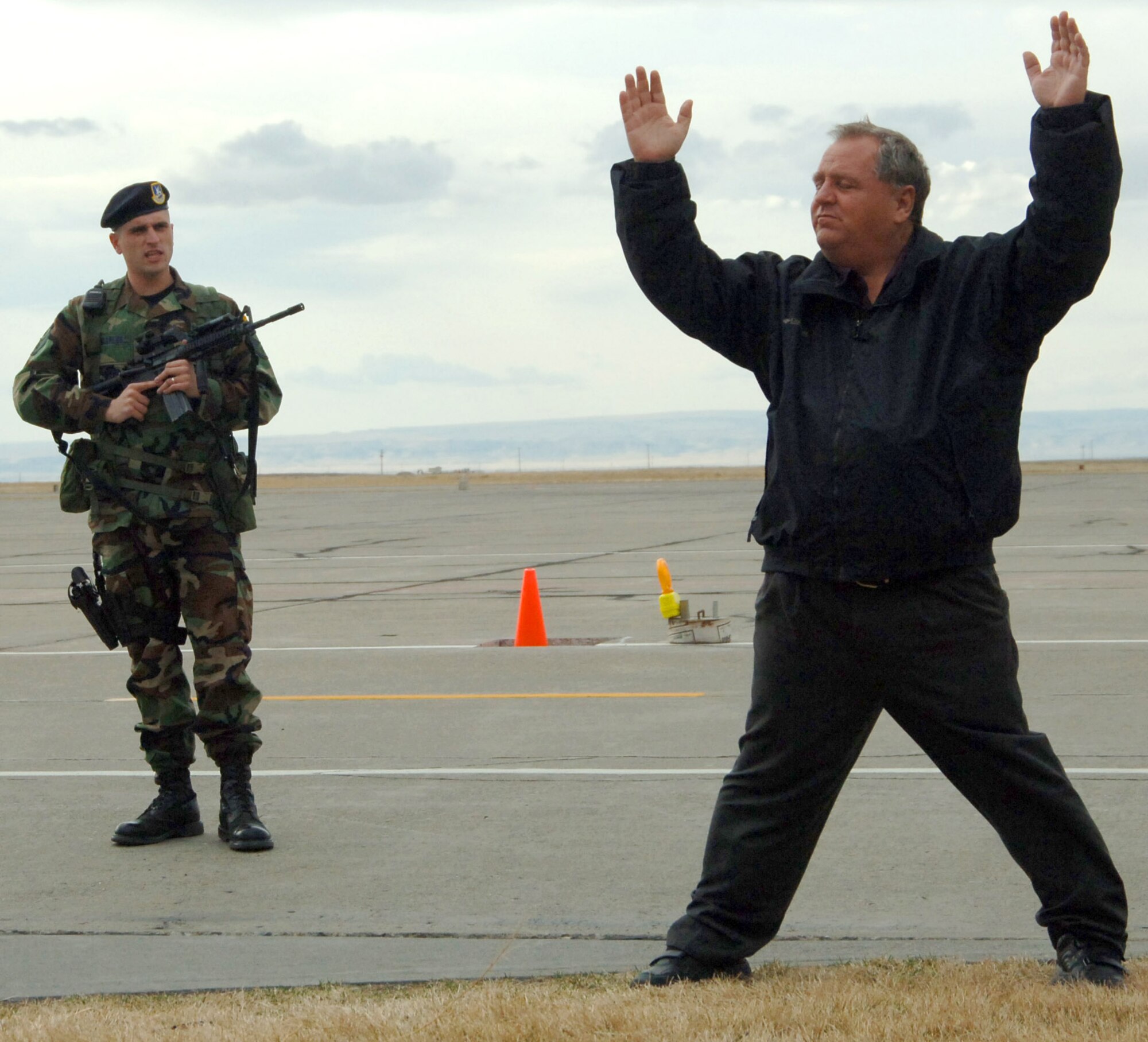 MOUNTAIN HOME AIR FORCE BASE, Idaho – Staff Sgt. Douglas Maples, 366th Security Forces Squadron, apprehends Gerald Weed after the civilian walked into a restricted area on the base’s flightline during a training exercise Feb. 22. The intrusion drill was part of Sharpshooter 07-01 -- a wing-wide mobility and combat readiness exercise which started Feb. 22. Mr. Weed serves with the 366th Fighter Wing’s Plans and Programs Office. Air Force photo by Tech. Sgt. Carly S. Burke