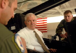 Secretary of Defense Robert Gates sits in the cockpit of an F-22A Raptor Feb. 22 as he and Senior Airman Jason Handt, 27th Fighter Squadron assistant dedicated crew chief, listen to Lt. Col. Dirk Smith, 94th Fighter Squadron commander, explain the capabilities of the aircraft. (U.S. Air Force photo/Airman 1st Class Vernon Young)
