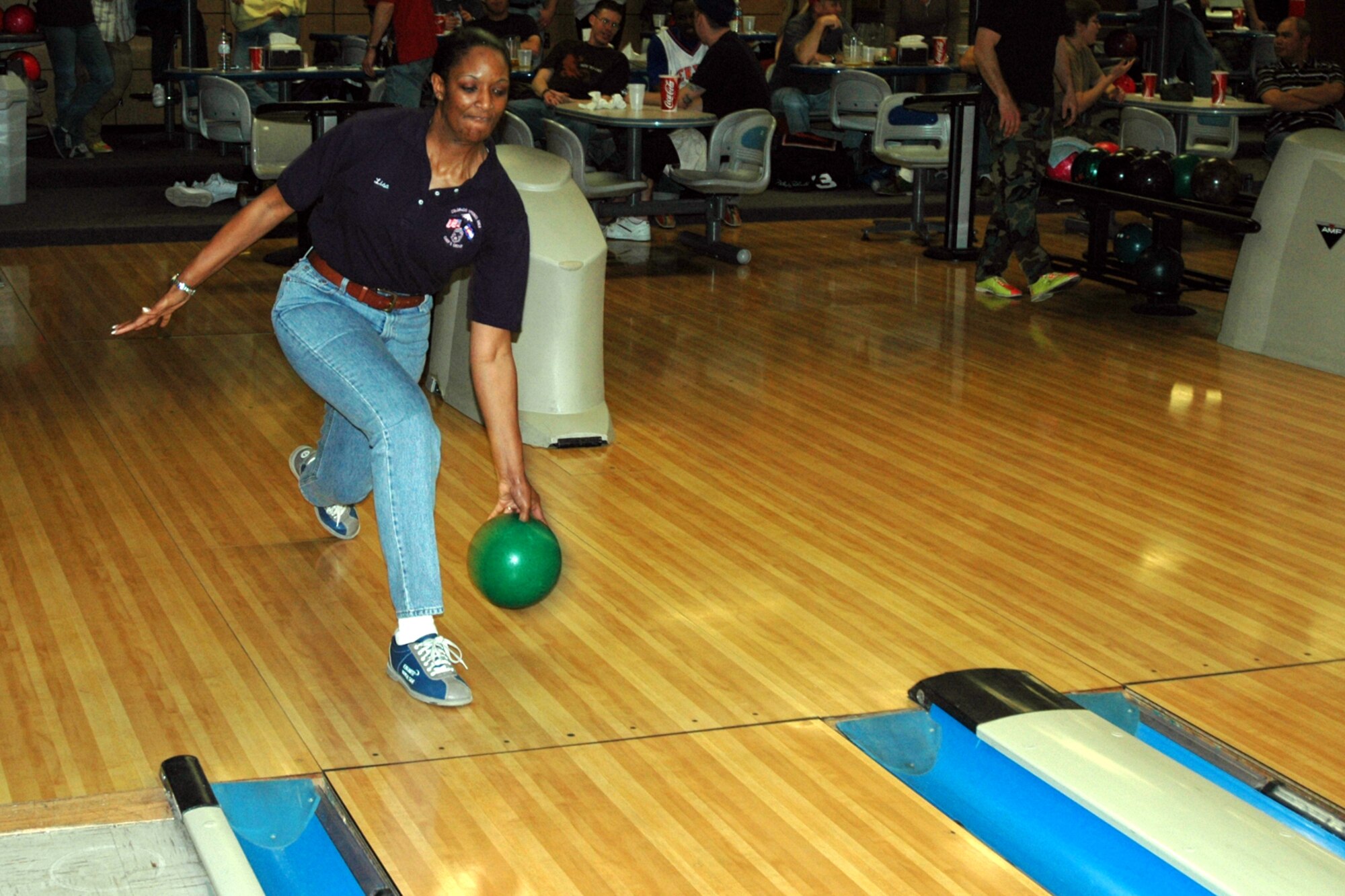 Chief Master Sgt. Lisa Godley, 50th Mission Support Group superintendent, rolls a frame Feb. 6 at the Peterson bowling alley during the Colorado Springs Area Chiefs’ Group bowl-a-thon. The fundraiser raised more than $5,300 for the group. (U. S. Air Force photo by Steve Brady)