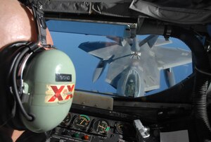 Tech. Sgt. Clifton Bond gives fuel from a 909th Air Refueling Squadron KC-135 to a F-22 Raptor over the Pacific Ocean on Feb. 18 while en route to Kadena Air Base, Okinawa, Japan for the first-ever overseas deployment of the F-22.
Twelve F-22s from the 27th Fighter Squadron deployed to the base as part of the recent Air and Space Expeditionary Force rotation.  Sergeant Bond is a boom operator with the 18th Operations Support Squadron at Kadena.  (U.S. Air Force photo/Senior Airman Jeremy McGuffin)
