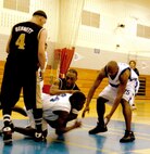 Warhawks' Ezell Trammell (44) works against Laughlin's R. Dobbins to keep possession after a rebound during the Southwest Military Basketball League championship Feb. 17 at Brooks City-Base, Texas. The men's varsity basketball team from Lackland Air Force Base, Texas, won the game 92-70. (USAF photo by April Blumer)                                
