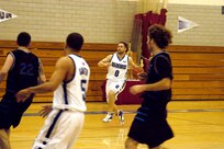 Warhawks' Aaron Winkler dribbles the ball down the court during the Southwest Military Basketball League championship Feb. 17 at Brooks City-Base, Texas. The men's varsity basketball team from Lackland Air Force Base, Texas, won the game 92-70. (USAF photo by April Blumer)                                