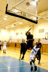 Both teams, including the two 21s, Warhawks' Paul Parker and Laughlin's R. Dobbins, watch to see if Parker's shot hits the mark during the Southwest Military Basketball League championship Feb. 17 at Brooks City-Base, Texas. The men's varsity basketball team from Lackland Air Force Base, Texas, won the game 92-70. (USAF photo by April Blumer)                                