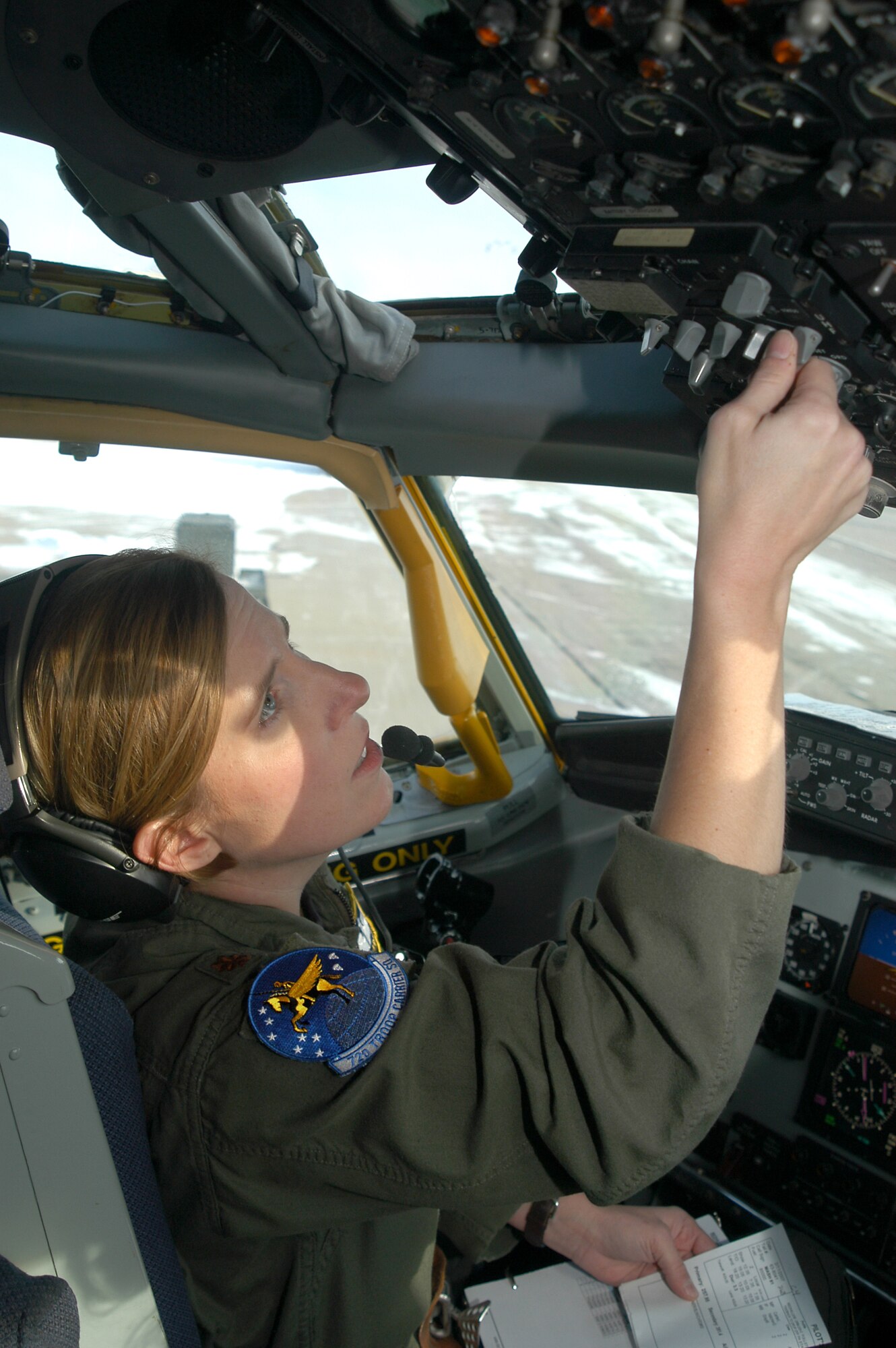 GRISSOM AIR RESERVE BASE, Ind., -- Maj. Liesl Carter, a KC-135R Stratotanker pilot, runs through her pre-departure checklist prior to an aerial refueling mission recently. Major Carter and other members of the 72nd Air Refueling Squadron have historical patches commemorating the 60th Anniversary of the Air Force. The patches are intended to remind members of the tradition and history of their unit. Members may wear the patches during several special observances during the year. (U.S. Air Force Photo/Senior Airman Mark Orders-Woempner)