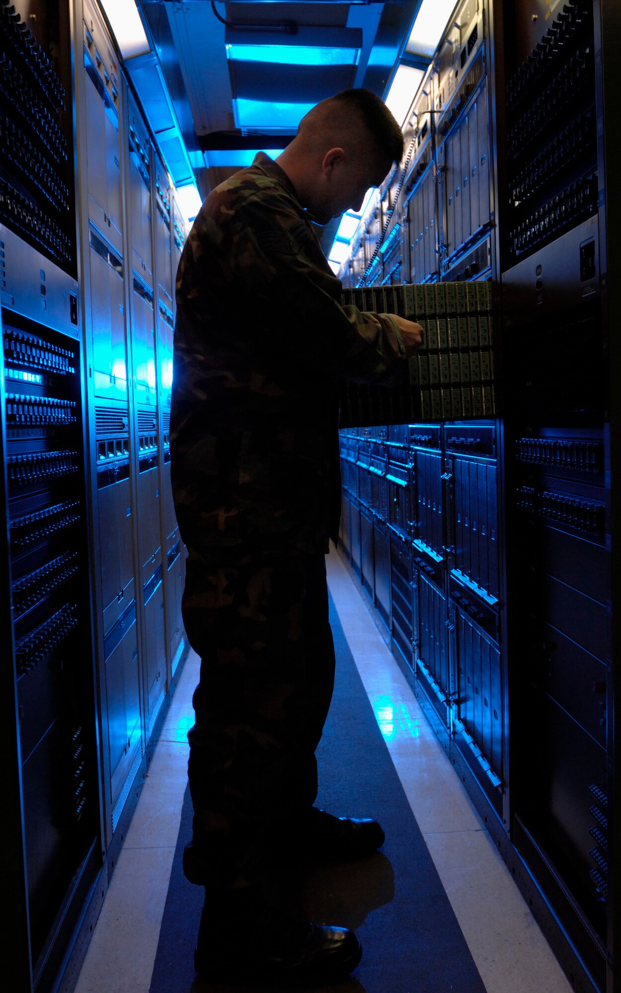Senior Airman Jason Wakefield, a voice network systems journeyman assigned to the 1st Communications Squadron, checks a set of telephone line cards during a routine inspection of the telephone network system here Feb. 21.
 More than 18,000 telephone line cards that support every telephone line connected to Langley. No telephone on the network can function without a working telephone line card. (U.S. Air Force photo/Staff Sgt. Eric T. Sheler)


