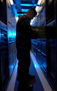 Senior Airman Jason Wakefield, a voice network systems journeyman assigned to the 1st Communications Squadron, checks a set of telephone line cards during a routine inspection of the telephone network system here Feb. 21.
 More than 18,000 telephone line cards that support every telephone line connected to Langley. No telephone on the network can function without a working telephone line card. (U.S. Air Force photo/Staff Sgt. Eric T. Sheler)


