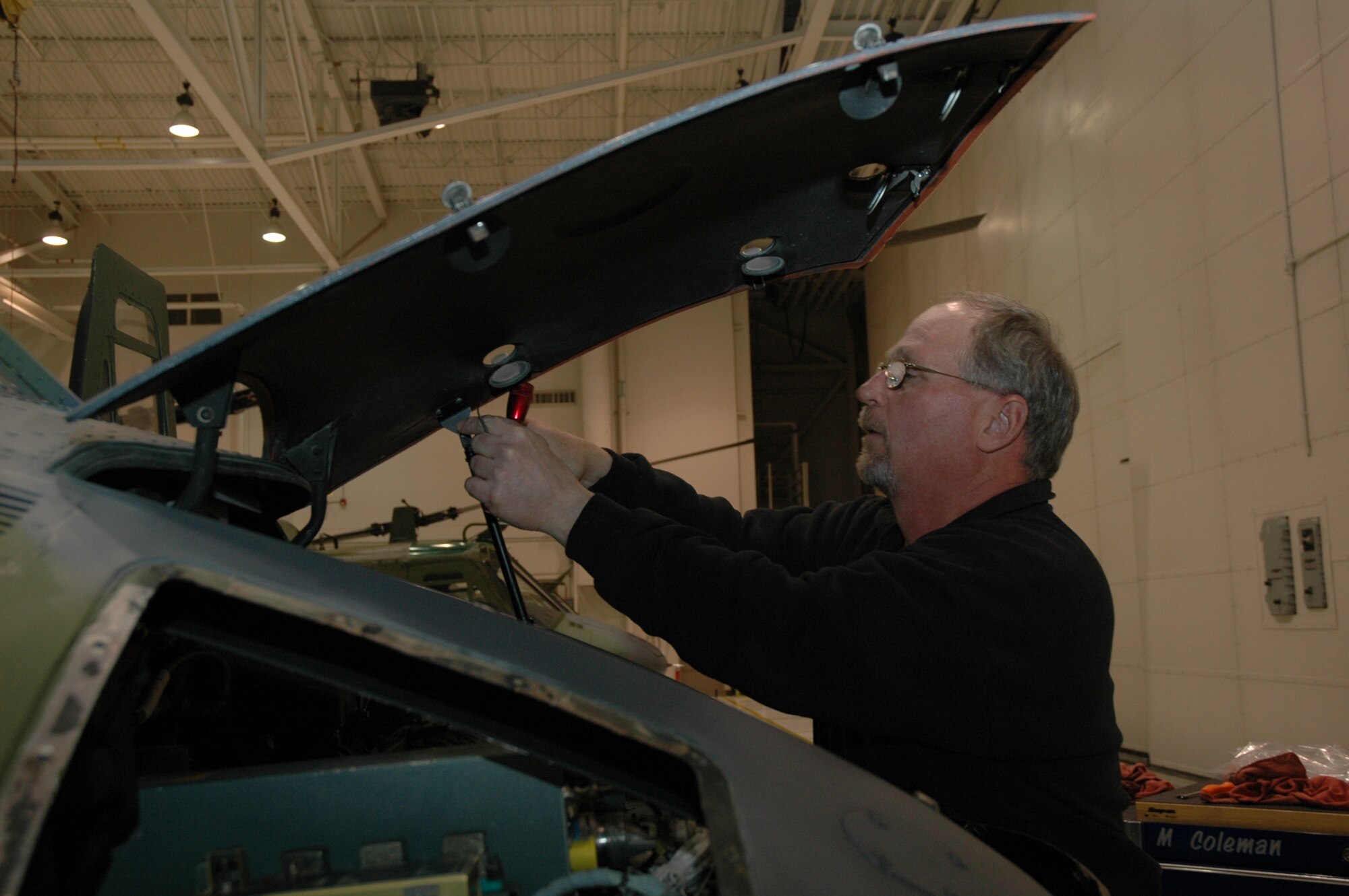 Dick Aspinwall changes a helicopter door during regularly scheduled maintenance.
