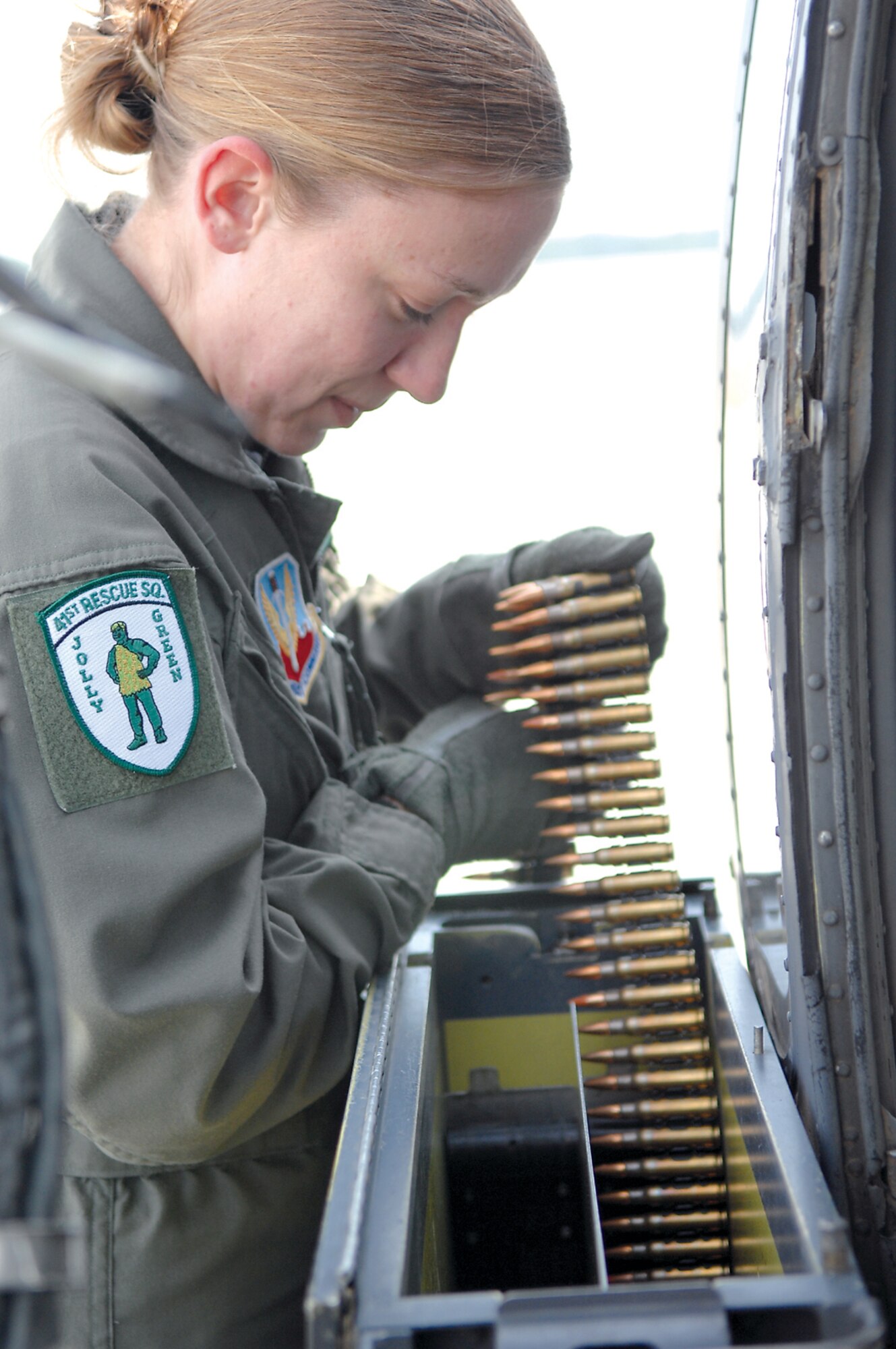 MOODY AIR FORCE BASE, Ga. -- Senior Airman Wendy Stombaugh, 41st Rescue Squadron aerial gunner, loads belts of 7.62mm ammunition into an HH-60G minigun magazine as a part of preflight procedures.  (U.S. Air Force photo by Airman 1st Class Gina Chiaverotti)
