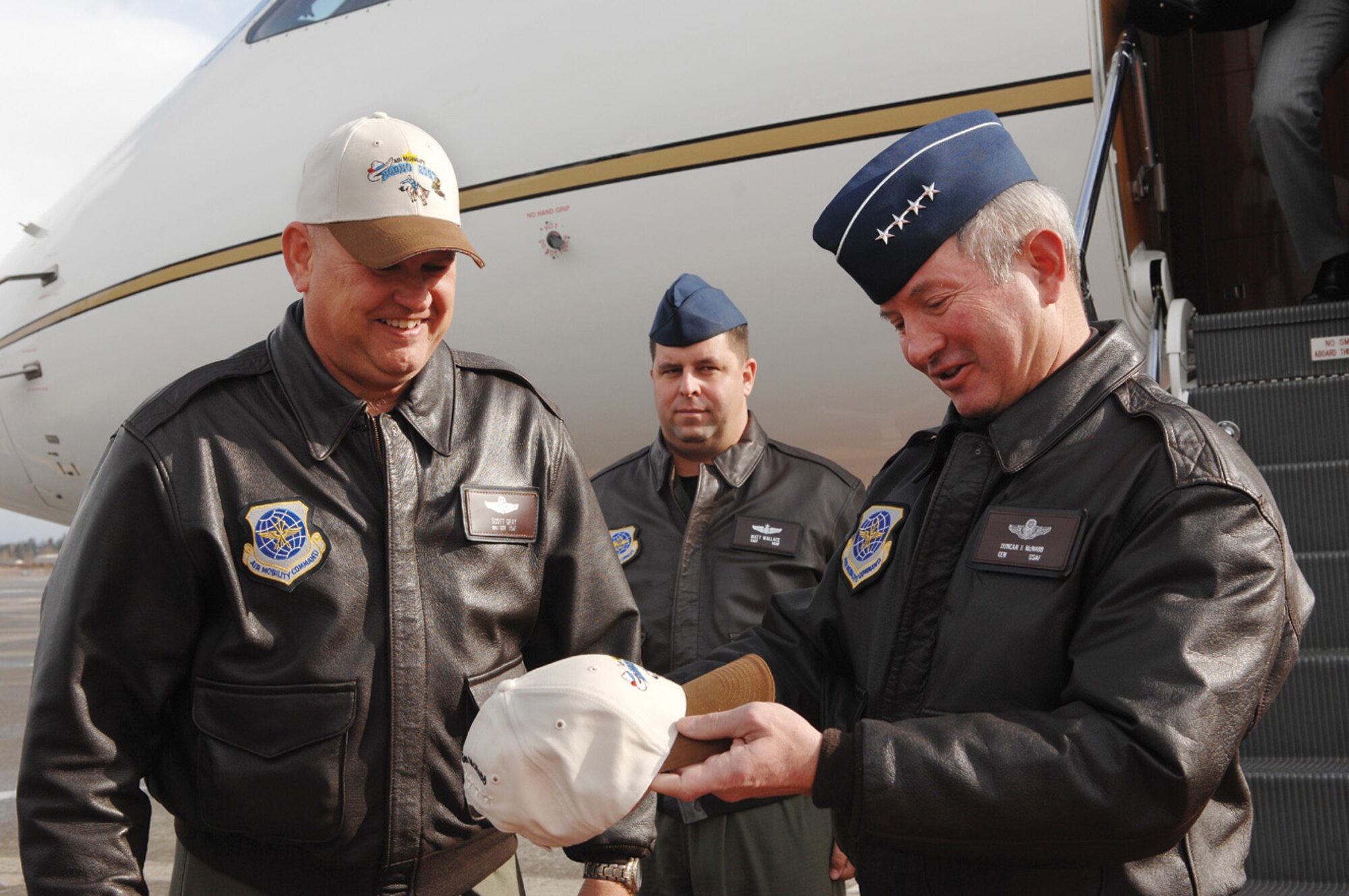 MCCHORD AIR FORCE BASE, Wash., -- Gen. Duncan McNabb, Air Mobility Command commander, right, is handed an AMC Rodeo 2007 hat by Maj. Gen. Scott Gray, Air Mobility Warfare Center commander, upon arriving at McChord Air Force Base Feb. 20 for a Rodeo in progress review visit. (U.S. Air Force photo by Abner Guzman) 