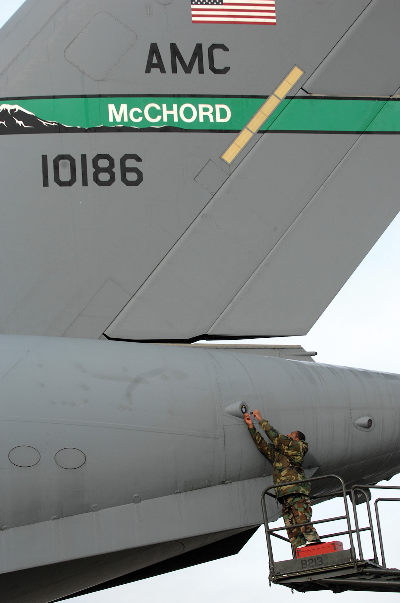 MCCHORDAIR FORCE BASE, Wash., -- Airman 1st Class Wesley Brown, 62nd Maintenance Squadron electronic warfare system technician, installs a large aircraft infared countermeasures sensor on a C-17 Globemaster III Feb 2.  The LAIRCM sensor is designed to provide directional input to the turret located to the rear of the aircraft. (U.S. Air Force photo by Abner Guzman) (Released)