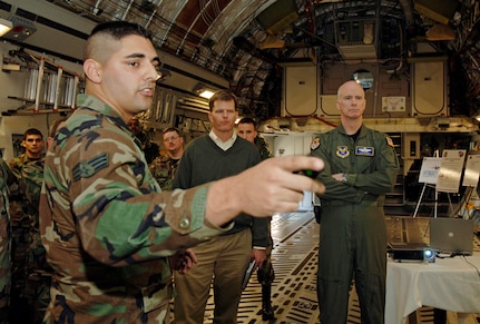 Senior Airman Nicholas Horine, 437th Maintenance Squadron maintenance coordinator, briefs Dr. Ron Ritter, AFSO 21 special assistant to the secretary of the Air Force, and Brig. Gen. S. Taco Gilbert, AFSO 21 chief, on the home station check lean initiative on the Charleston AFB, S.C., flightline Feb. 16. (U.S. Air Force photo/Staff Sgt. April Quintanilla)