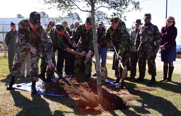 Arbor Day was celebrated at Hurlburt Feb. 16 with the ceremonial planting of a tree outside of Air Force Special Operations Command headquarters. Assisting with the planting are (left to right) Maj. Richard Dwyer, 1st Special Operations Civil Engineer Squadron commander, Chief Master Sgt. James Kradel, 1st Special Operations Wing acting command chief, Col. Norman Brozenick, 1st SOW commander, and Lt. Col. Steven Kimball, 1st Special Operations Mission Support Group deputy commander. (U.S. Air Force photo by Jamie Haig)