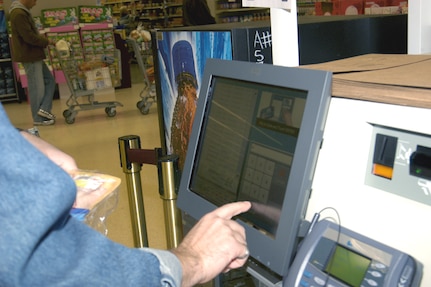Customers using the new self-check kiosks at the commissary on Lackland Air Force Base, Texas, have the option to scan the barcode, type in the price look-up code or identify the product by image. The Lackland Commissary is one of five testing sites for the new IBM hardware and software systems the Defense Commissary Agency is looking to use worldwide. (USAF photo by April Blumer)                                