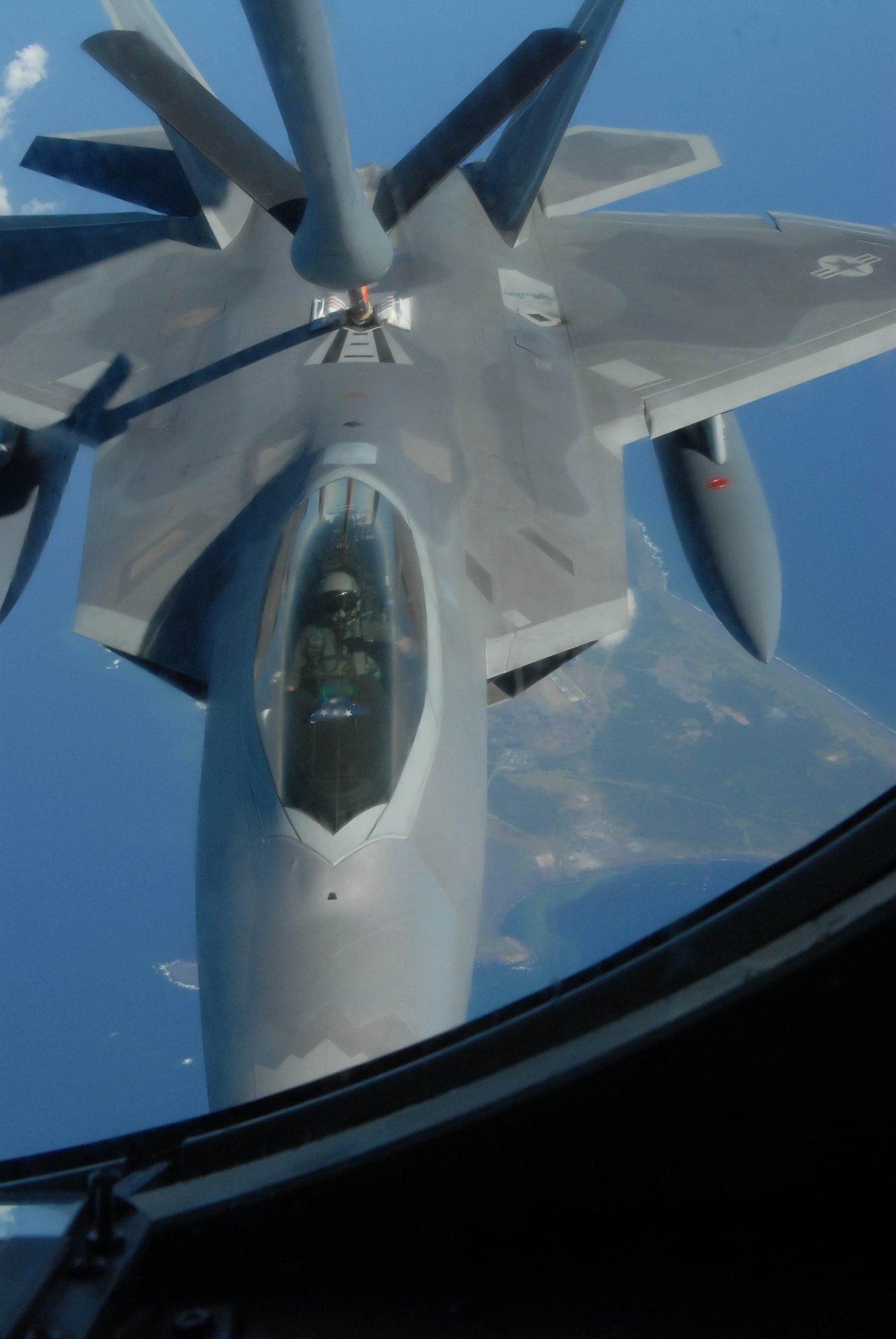 An F-22 Raptor receives fuel from a 909th Air Refueling Squadron KC-135 Stratotanker over Iwo Jima Feb. 18 while en route to Kadena Air Base, Okinawa, Japan. This was the first-ever overseas deployment of the F-22. F-22s from the 27th Fighter Squadron at Langley Air Force Base, Va., are deployed to Kadena AB as part of an Air Expeditionary Force rotation. (U.S. Air Force photo/Senior Airman Jeremy McGuffin)