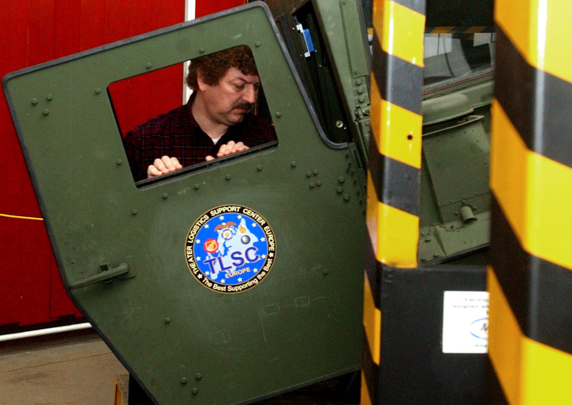 Dietmar Malek, technical engineer for the HEAT A1 project, inspects the device’s humvee cabin Feb. 14 prior to a demonstration at Maintenance Activity Kaiserslautern. Photo by Pfc. Stephen Decatur 
