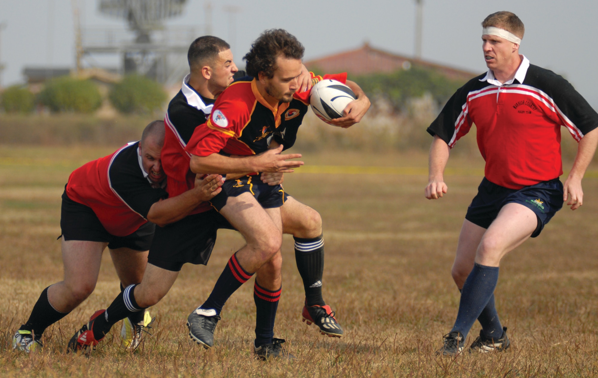 OSAN AIR BASE, Republic of Korea --  Members of Camp Humphreys’ Warriors Rugby Team attempt to take down a member of the Survivors Ruby Club. Six teams from around the peninsula traveled to Osan to participate in the Halloween Rugby 10s Tournament. (U.S. Air Force photo by Staff Sgt. Josh Klahn)