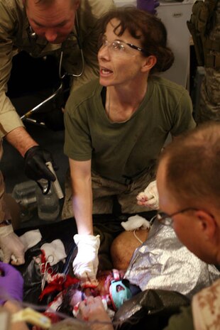 Navy Cmdr. Pamela Harvey treats an Iraqi victim of a Feb. 24, 2007 suicide truck bomb blast in Al Habbiniyah, Iraq. Harvey served in Iraq from Aug. 2006 to March 2007