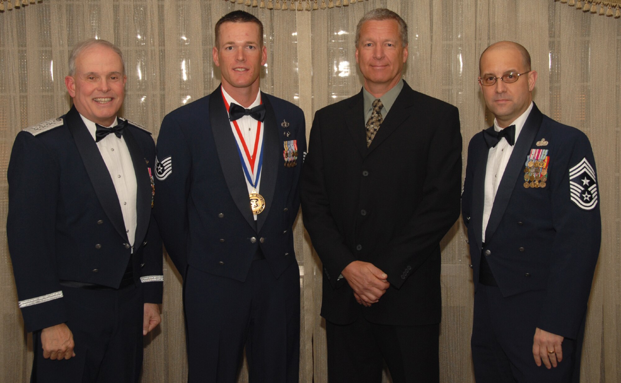 OSAN AIR BASE, Republic of Korea --  Tech. Sgt. Jesse Jacobson, assigned to the Pacific Air Forces Silver Flag Exercise Site in Kadena AB, Japan, is the 7th Air Force annual award winner in the Noncommisioned Officer category. Here he poses with Lt. Gen. Stephen Wood, 7th AF commander, and Chief Master Sgt. Raymond Allen III, 7th AF command chief.