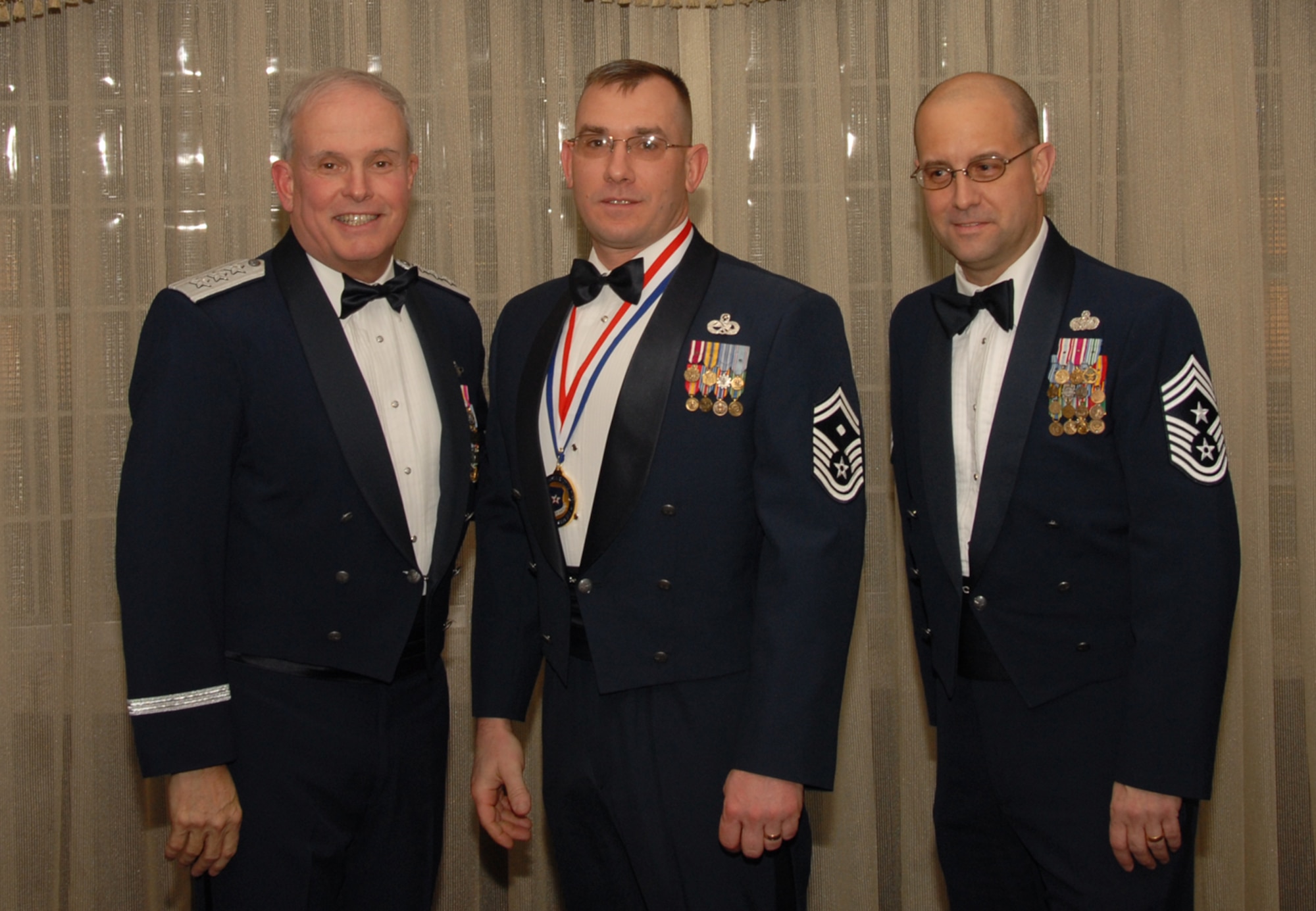 OSAN AIR BASE, Republic of Korea --  Senior Master Sgt. James Winkels, 51st Logistics Readiness Squadron, is the 7th Air Force annual award winner in the First Sergeant category. Here he poses with Lt. Gen. Stephen Wood, 7th AF commander, and Chief Master Sgt. Raymond Allen III, 7th AF command chief. 