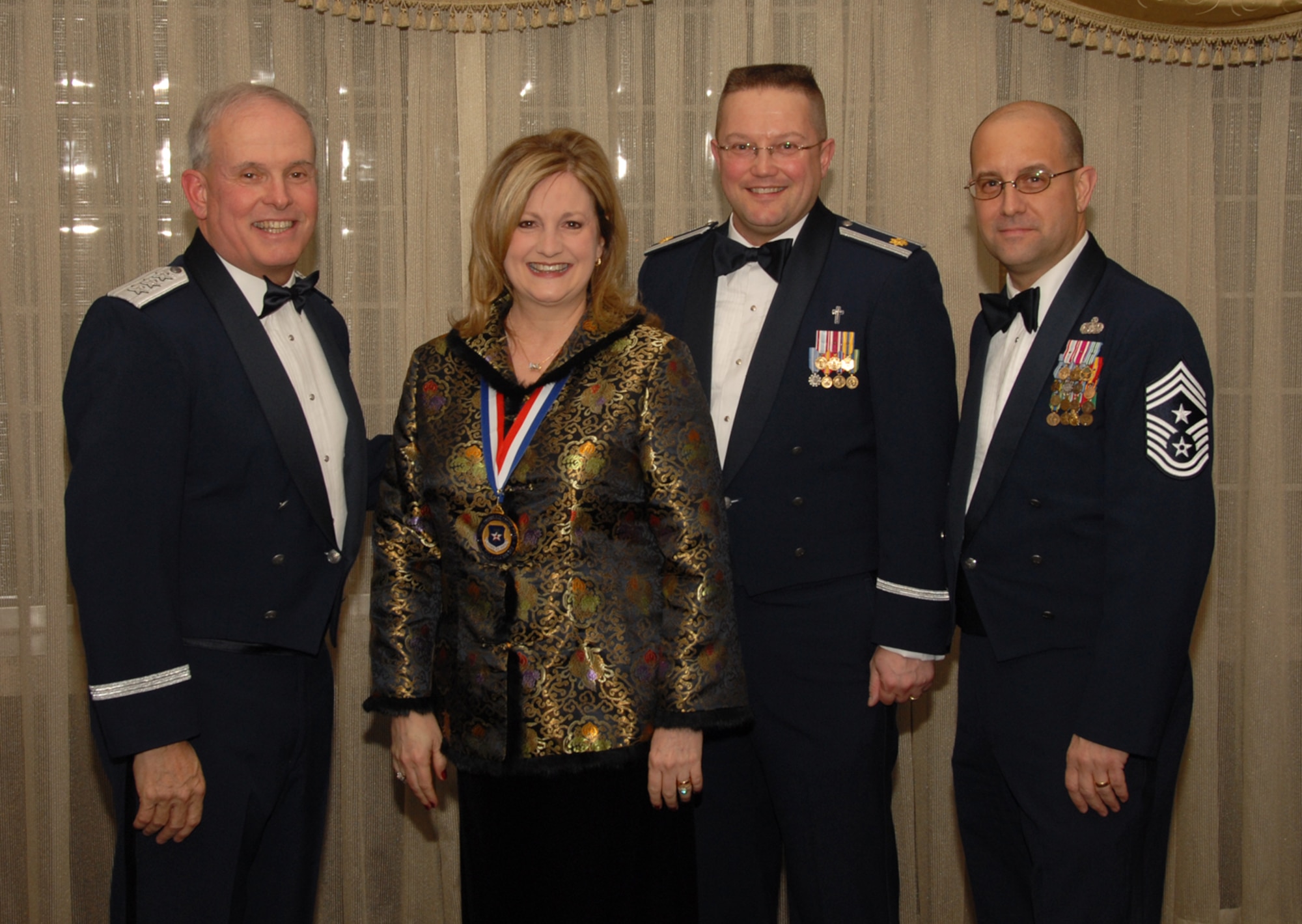 OSAN AIR BASE, Republic of Korea --  Mrs. Sherri Kitchens, 51st Mission Support Squadron, is the 7th Air Force annual award winner in the Civilian Manager/Supervisor/Professional category. Here she poses with Lt. Gen. Stephen Wood, 7th AF commander, and Chief Master Sgt. Raymond Allen III, 7th AF command chief. 