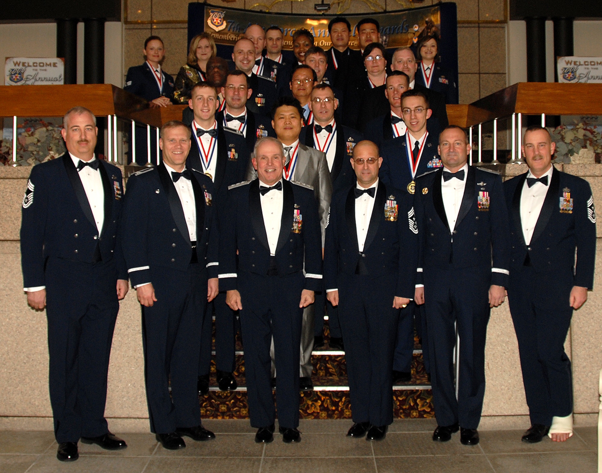 OSAN AIR BASE, Republic of Korea --  Seventh Air Force annual award winners and nominees pose for a photo with the 7th AF, 51st Fighter Wing and 8th Fighter Wing commanders - Lt. Gen. Stephen Wood, Brig. Gen. Joe Reynes and Col. Jeff Lofgren - and their respective command chief master sergeants. The award banquet took place at the Osan Officers' Club Feb. 24. (U.S. Air Force photo by Staff Sgt. Chrissy Fitzgerald)