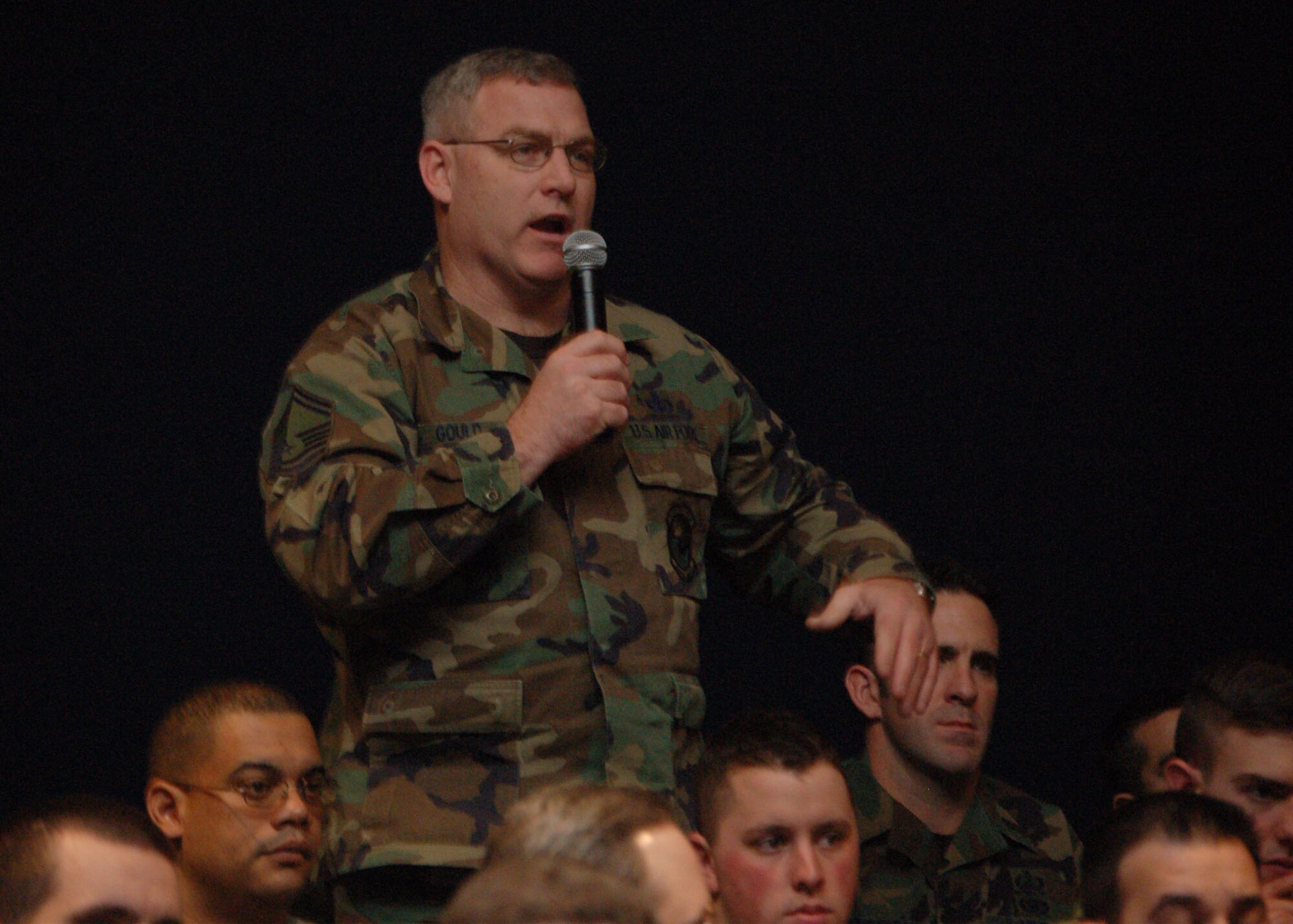 Senior Master Sgt. Mort Gould, superintendent of the 3rd Contracting Squadron, asks Chairman of the Joint Chiefs of Staff Marine Gen. Peter Pace a question during a town hall meeting at Elmendorf Air Force Base, Alaska, Feb. 23. (U.S. Air Force photo/Staff Sgt. Matthew Rosine) 
