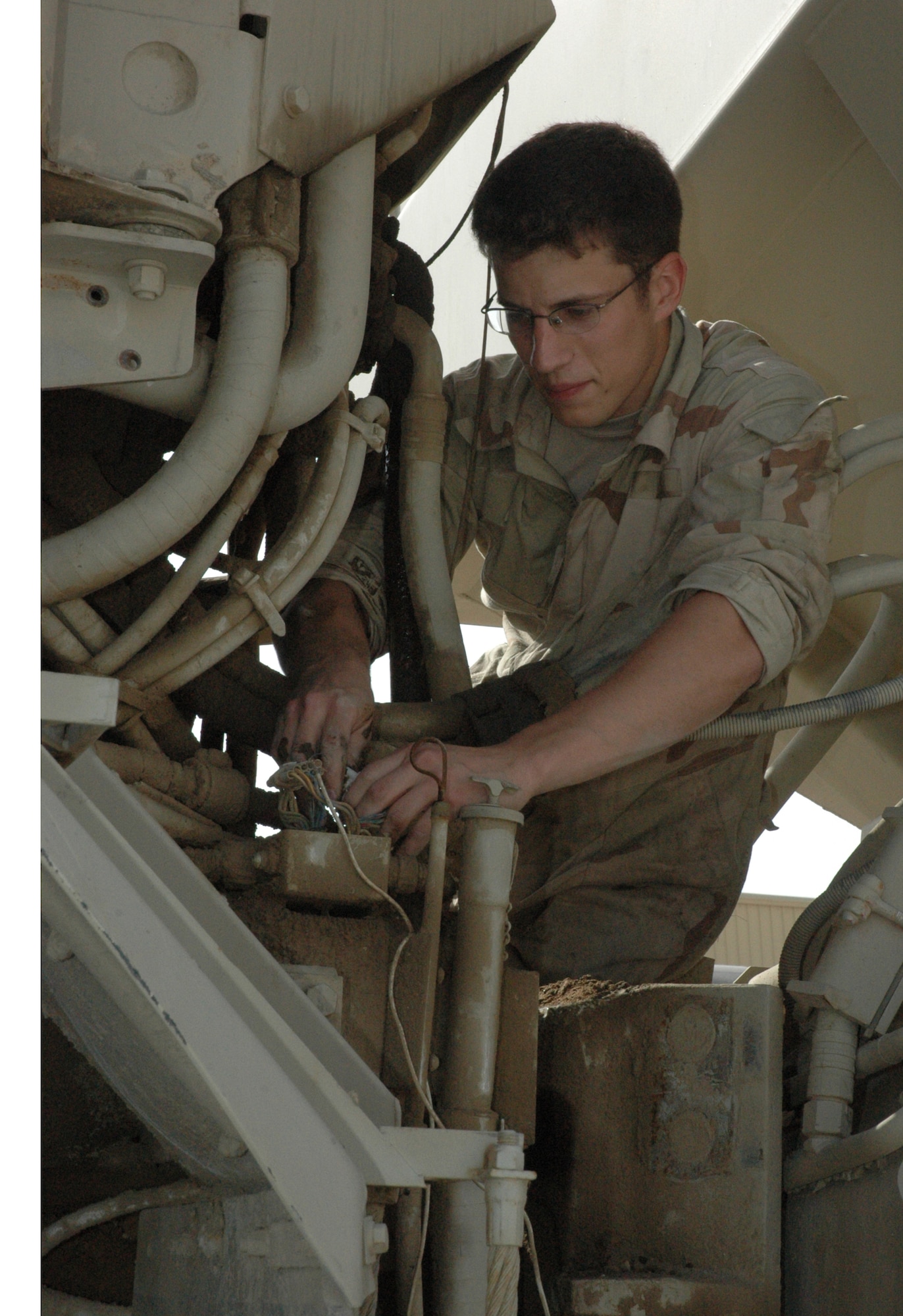 Senior Airman Nic Skirpan, 1st ERHG vehicle maintenance journeyman, inspects engine components and hydraulic fittings on a 20-ton rock dump. RED HORSE vehicles from all over the AOR are sent back to the 379th AEW for maintenance and repair work. (U.S. Air Force photo by Senior Airman Erik Hofmeyer)