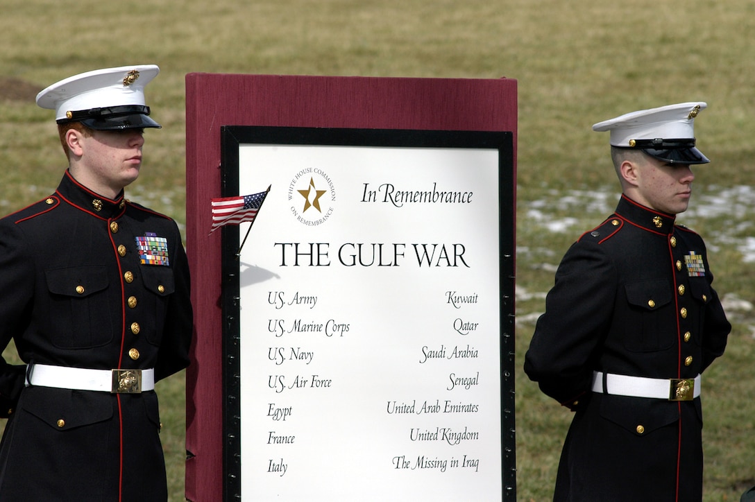 Two Marines stand by the Remembrance Panel, where Kuwaiti children were escorted by representatives of countries who suffered casualties in the Gulf War to place flags on the panel. The countries are Egypt, France, Italy, Qatar, Saudi Arabia, Senegal, United Arab Emirates and the United Kingdom, those listed as missing in Iraq also were honored. Photo by Rudi Williams