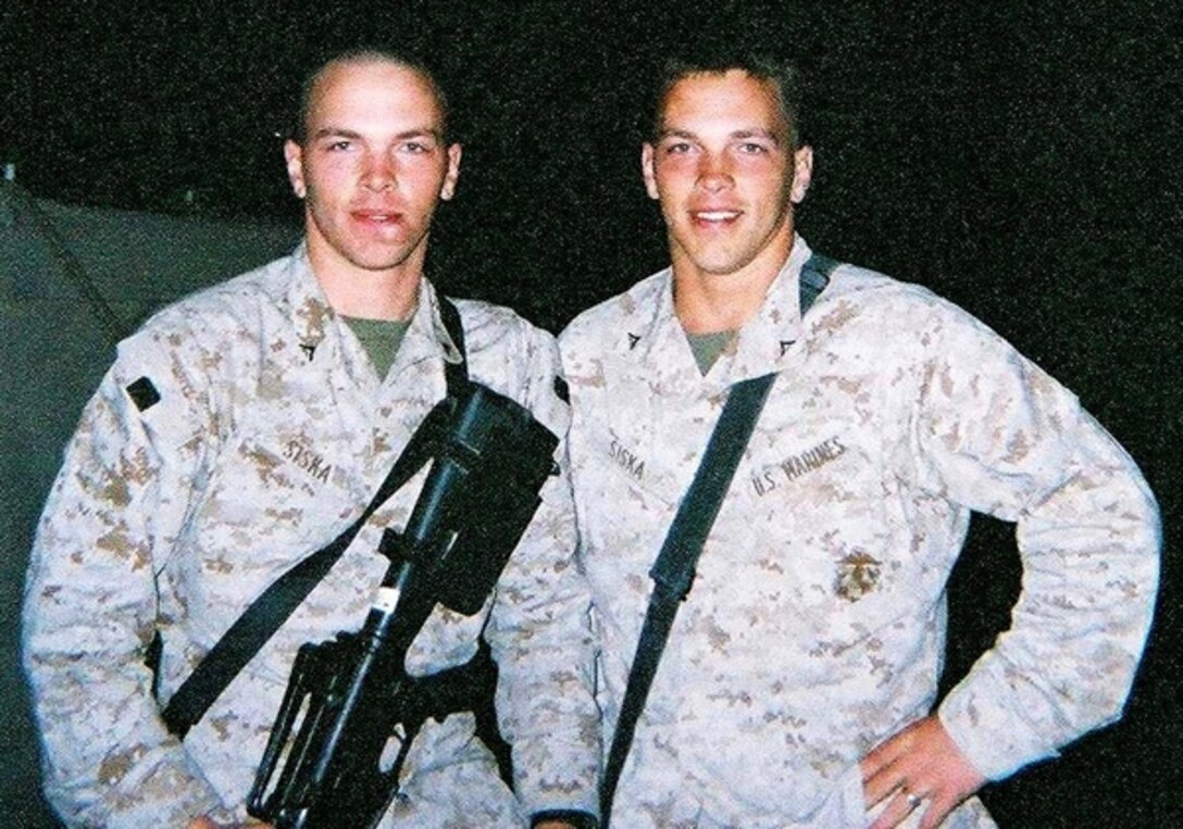 Identical twins Marine Lance Cpls. Kevin Siska (left) and Scott Siska had not seen each in 14 months when they were reunited in Kuwait on March 8 as Scott was leaving Iraq with his unit after a seven-month tour and Kevin was on his way into Iraq for a similar tour. Courtesy photo