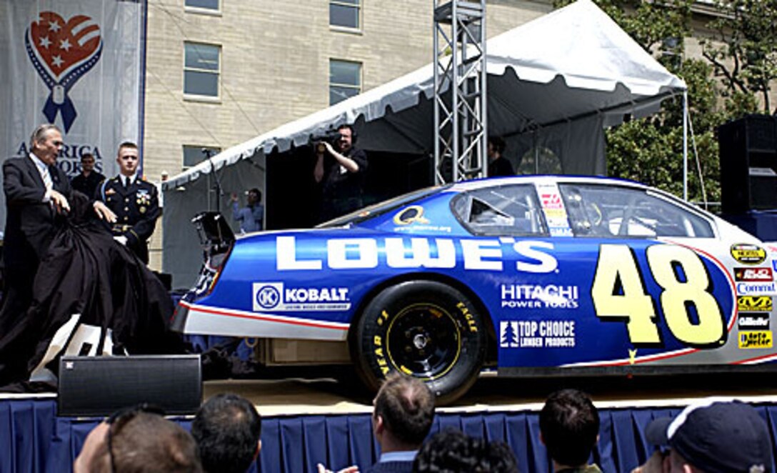 Defense Secretary Donald Rumsfeld unveils a NASCAR car bearing the "America Supports You" decal on the deck-lid during the first America Supports You Salute to Our Military Men and Women concert May 5. Lowe's joined the America Supports You team. Photo by Tech. Sgt. Cherie A. Thurlby, USAF