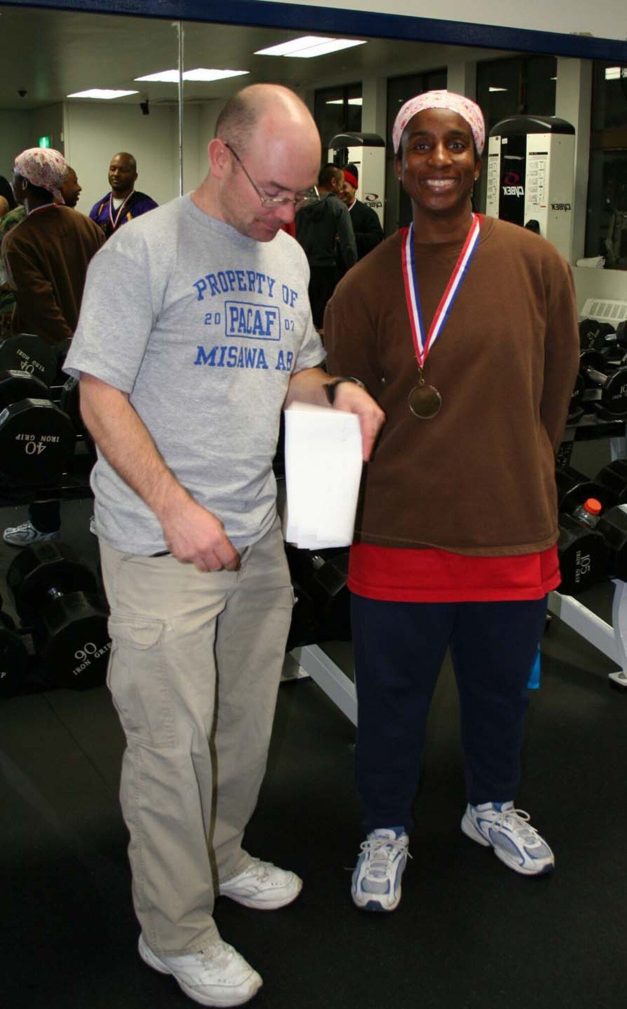 070217-- MISAWA AIR BASE, Japan -- Senior Master Sgt. Tina Heggins, 301st Intelligence Squadron, with a total weight of 390 pounds during a weight lifting competition here at the Potter Fitness Center Feb. 17. Eighteen contestants competed in the bench press and dead lift in light, medium, and heavy weight divisions. (Courtesy photo)