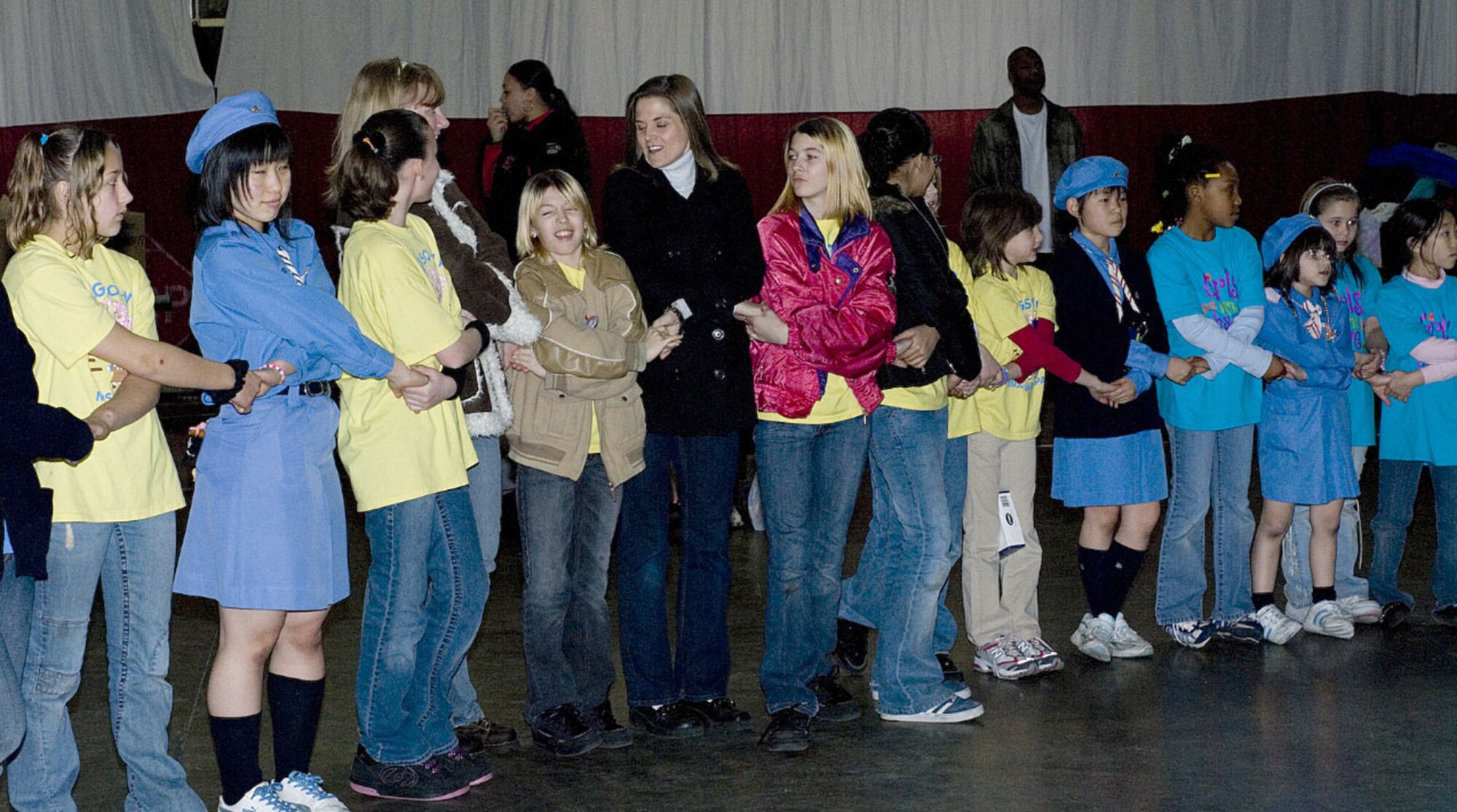 070225 -- MISAWA AIR BASE, Japan -- U.S. and Japanese Girl Scouts join hands during Thinking Day Feb. 25 in Hanger 949. Thinking Day gives the American and Japanese Girl Scouts an opportunity to interact and share their culture. During the one-day exchange, they had lunch together, shared swaps, and exchange gifts. More than 100 children participate in this event each year. (U.S. Air Force photo by Holly Williams)