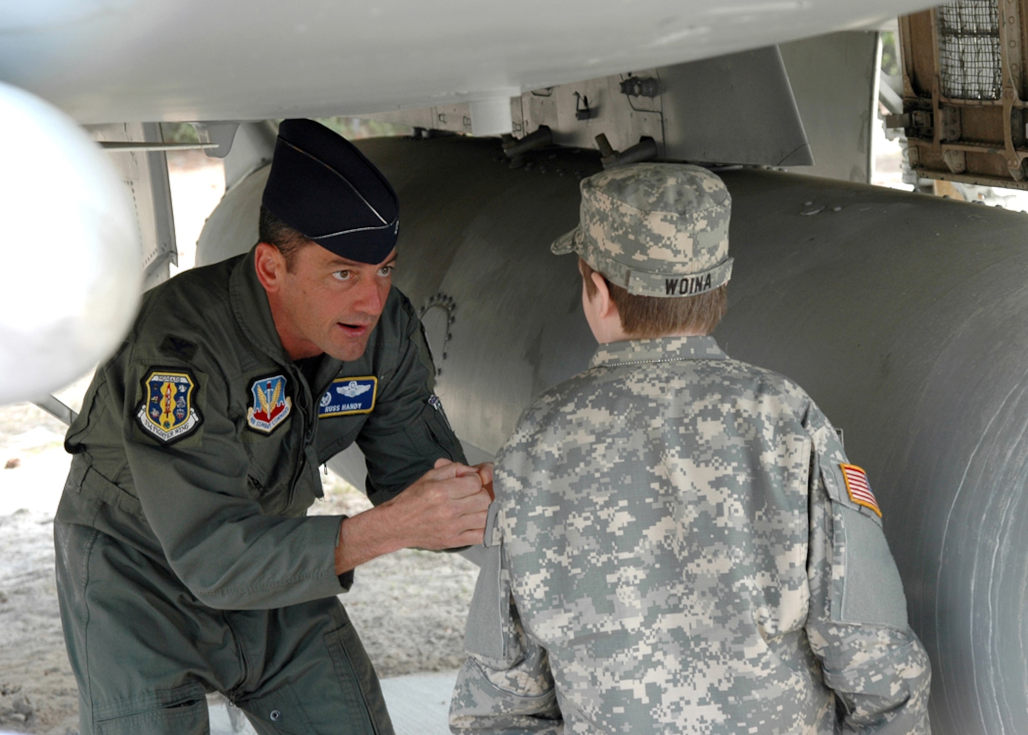 EGLIN AIR FORCE BASE, Fla. -- Col. Russ Handy, 33d Fighter Wing Commander, explains the workings of the F-15C Eagle?s 20mm Gatling gun Feb. 26 to Riley Woina, 14, from Connecticut, who was diagnosed with cystic fibrosis. Riley spent Feb. 19-24 at Eglin Air Force Base with the 6th Ranger Training Battalion as part of the Make-A-Wish Foundation. (USAF photo by Staff Sgt. Bryan Franks)